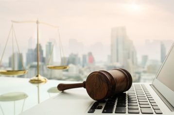 An image featuring a gavel on top of a laptop representing data privacy laws concept