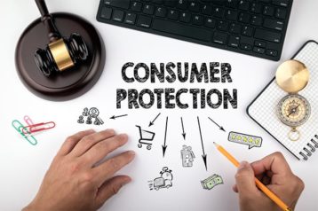 An image featuring consumer protection concept with a gavel next to it and a laptop